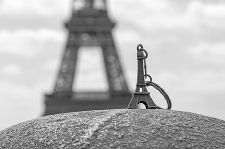 Eiffel tower keychain against real Eiffel towerの写真素材