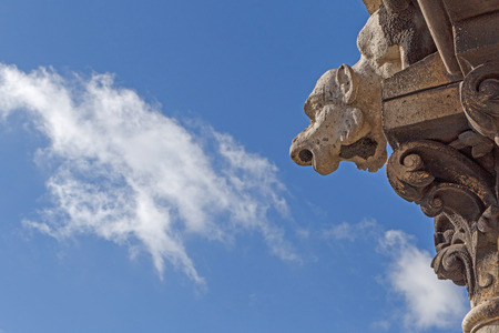 gargoyle on The Basilica of the Sacred Heart of Paris against blue skyの写真素材