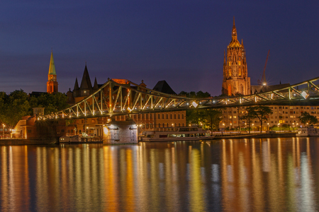 view on footbridge and old center of Frankfurt am Main at nightの写真素材