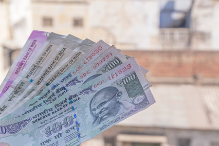 Indian rupee banknotes against old buildingsの写真素材