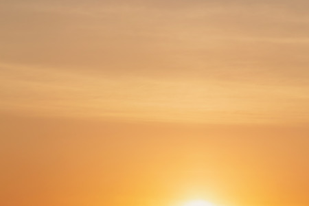 abstract natural background: view of sky with rising sunの写真素材