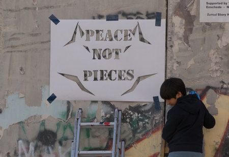 BETHELEM, PALESTINE - MAY 20, 2017:  Palestinians make graffiti on Israeli West Bank barrier in Bethlehemのeditorial素材
