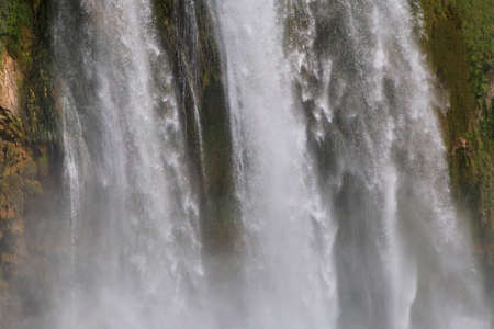 view on several waterfalls falling from rockの写真素材