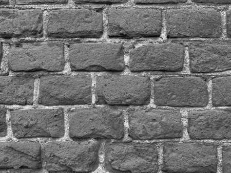 black and white photo of old brick wallの写真素材