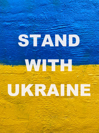 Stand with Ukraine message on Ukrainian national flag painted on wallの写真素材