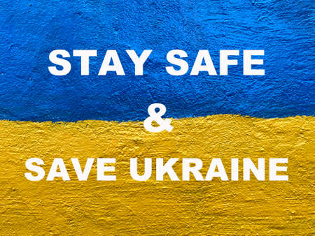 Stay Safe and Save Ukraine message on Ukrainian flag painted on wallの写真素材