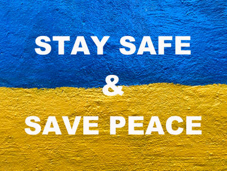 Stay Safe and Save Peace message on Ukrainian flag painted on wallの写真素材