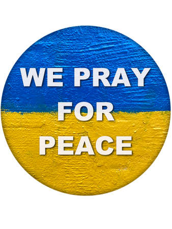 round button with We pray for peace message on Ukrainian flag painted on wallの写真素材
