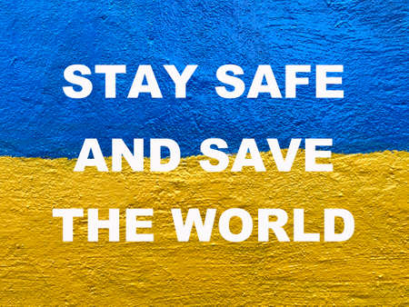 message Stay safe and save the world on Ukrainian flag painted on wallの写真素材