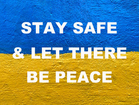 message Stay safe and let there be peace on painted Ukrainian Flagの写真素材