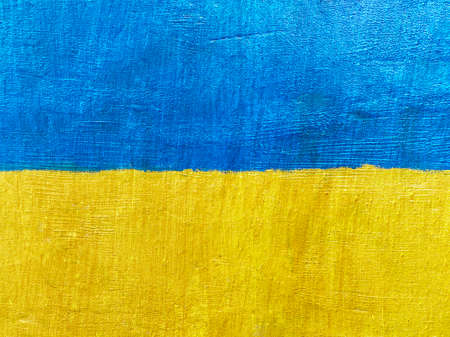 Stand with Ukraine backdrop:  flag of Ukraine painted on stone wallの写真素材