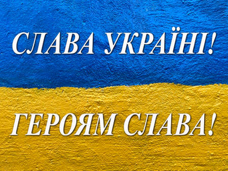 slogan Glory to Ukraine, Glory to Heroes in Ukrainian on flag painted on wallの写真素材