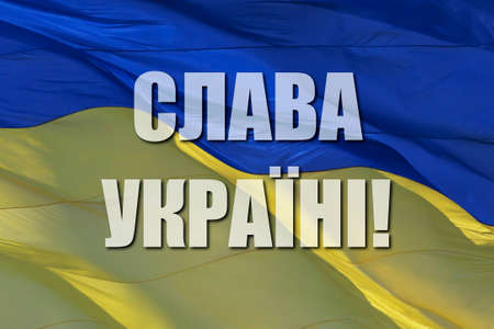 slogan Glory to Ukraine in Ukrainian on waved national flagの写真素材