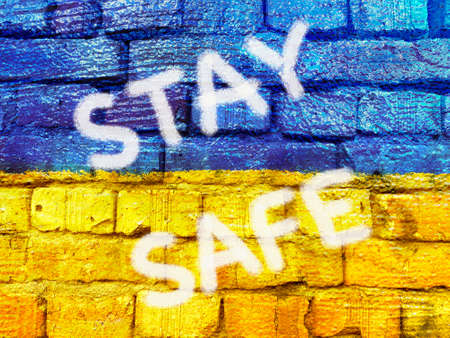 slogan Stay Safe on Ukrainian flag painted on brick wallの写真素材