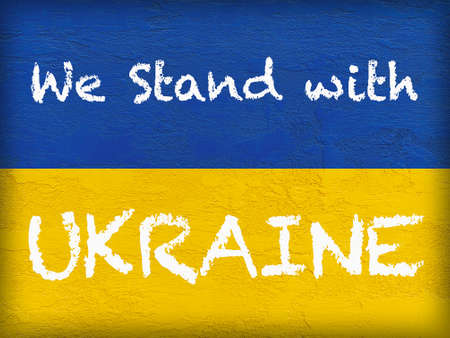 message We stand with Ukraine on Ukrainian flag painted on stone wallの写真素材