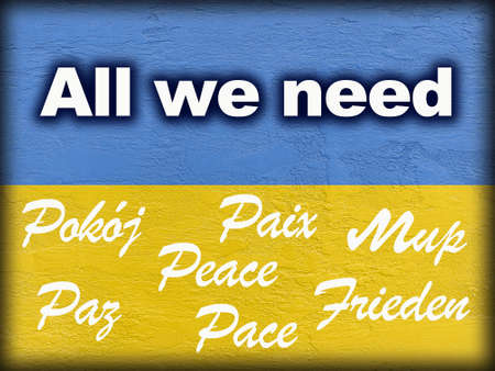 message All we need and word Peace in several languages on Ukrainian flag painted on wallの写真素材