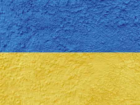 Stand with Ukraine backdrop: Ukrainian flag painted on wallの写真素材