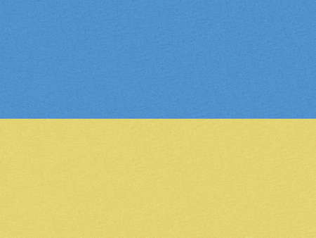 Stand with Ukraine backdrop: Ukrainian flag painted on paperの写真素材