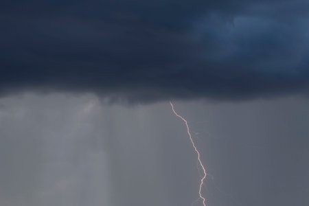 view on stroke of lightning from dark thunderstorm cloud