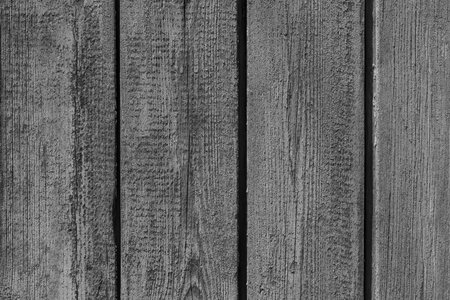 old dark gray wooden fence made of planks backgroundの写真素材