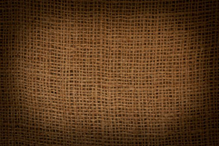 close up of dark brown sacking texture with darker borderの写真素材