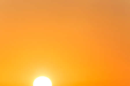 view on clear orange sky with rising sunの写真素材