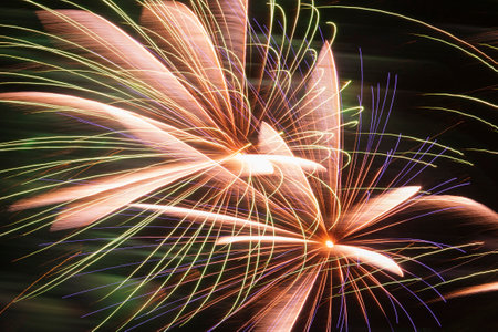 abstract holiday background: close up of fireworks in night skyの写真素材
