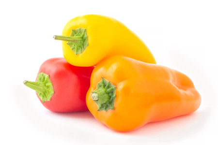 yellow, red and orange mini sweet peppers isolated on whiteの写真素材