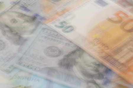 abstract financial background: blurred dollars, euro and hrivnya banknotesの写真素材