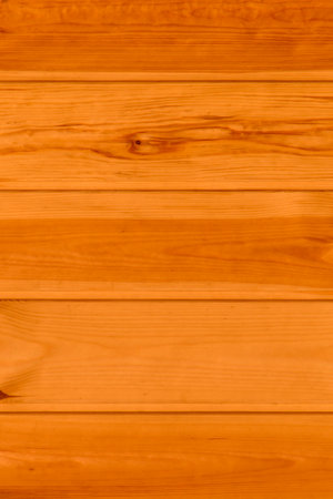 close up of light brown wooden wall made of planks backgroundの写真素材