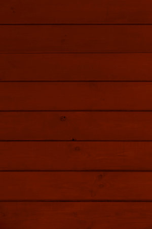 close up of dark reddish wooden wall made of planks backgroundの写真素材