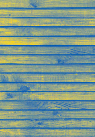 wooden wall made of planks colored in colors of Ukrainian flag backdropの写真素材