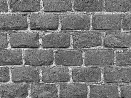 construction background: black and white photo of wall made of bricksの写真素材
