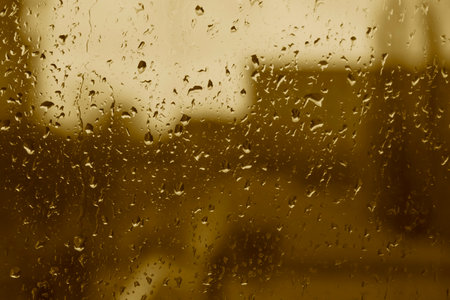close up of rain drops on glass of windowの写真素材