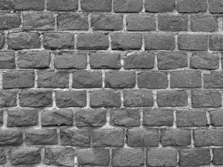 black and white photo of old brick wallの写真素材