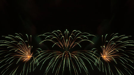abstract holiday background: green fireworks in night skyの写真素材