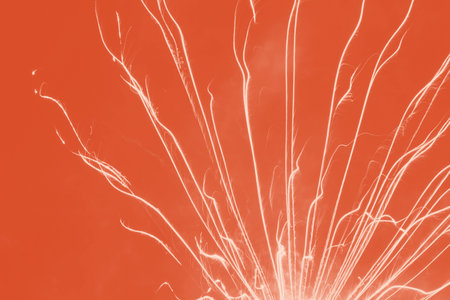 abstract holiday background: bright firework burst against red backgroundの写真素材