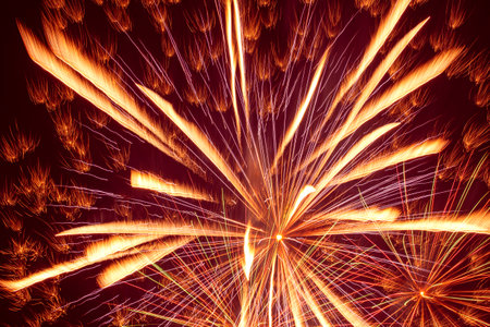 abstract holiday background: bright fireworks against night skyの写真素材