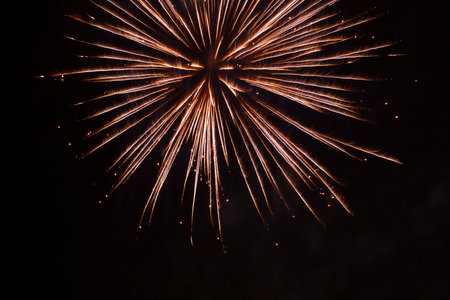 abstract holiday background: bright firework burst against night skyの写真素材