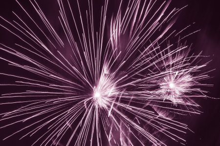 abstract holiday background: bright firework burst against dark violet skyの写真素材