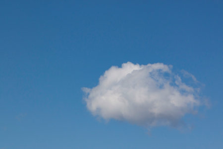 view on single cloud in a clear blue skyの写真素材
