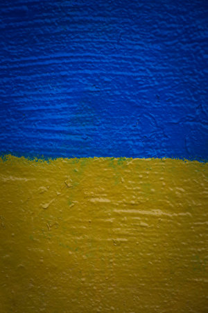 stand with Ukraine background: flag of Ukraine painted on wallの写真素材