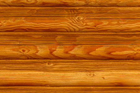 close up of bright  brown with yellow wall made of logs backgroundの写真素材