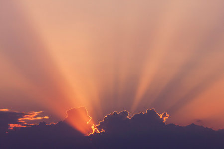 view on sunshine in a sky from sun hidden behind cloudsの写真素材