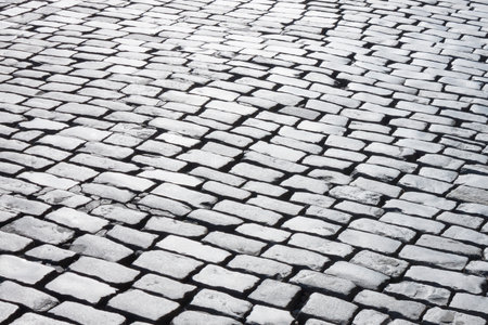 black and white photo of old cobblestone roadの写真素材