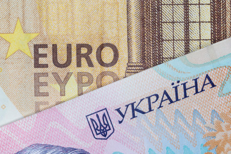 close up of fifty euro and two hundred Ukrainian hrivnya banknotes