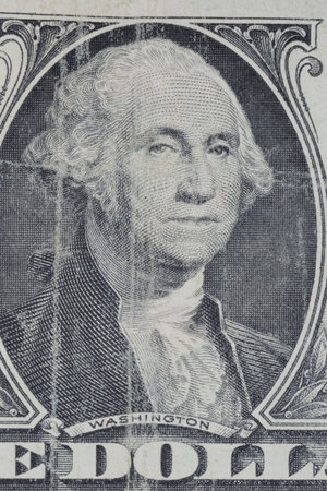close up of portrait of Washington on shabby one United States dollar banknote