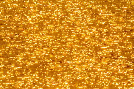 abstract background: view on golden sunshine in waterの写真素材