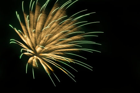 abstract holiday background: bright fireworks against dark night skyの写真素材