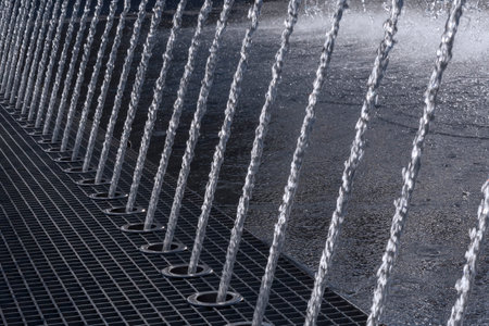 close up of row of water jets in fountainの写真素材